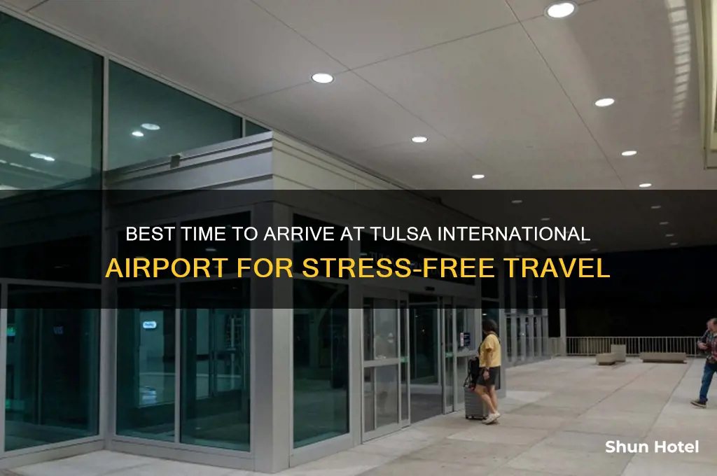 when should i arrive at tulsa international airport
